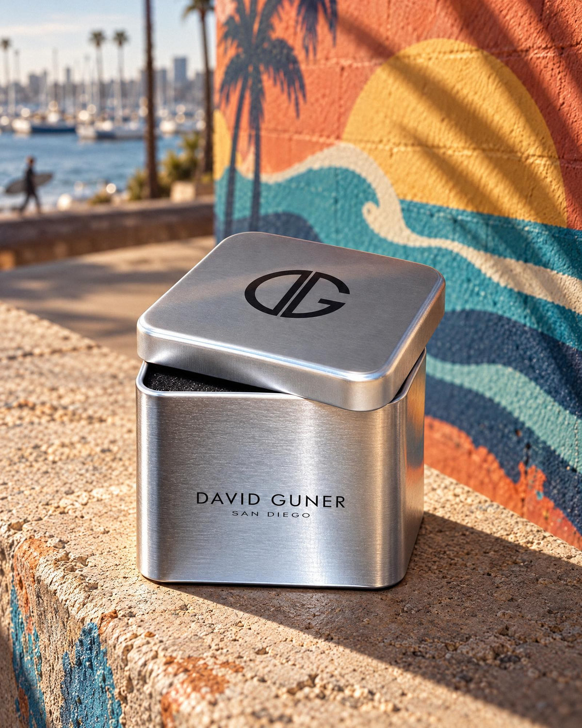 The David Guner silver-tone tin with the DG monogram on its lid